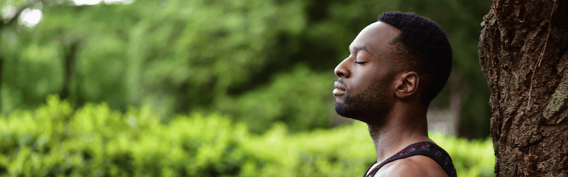 Black Man in Woods Reflecting on 2024 Being Mindful