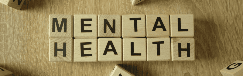 Scrabble Board Pieces Creatively Spelling Out the Phrase "Mental Health" in a Banner Style Image